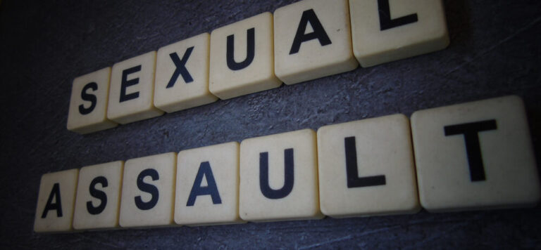 Sexual,Assault,,Word,Cube,With,Background.