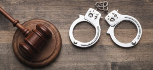 Arrest,Concept.,Metal,Handcuffs,Near,Judge,Gavel